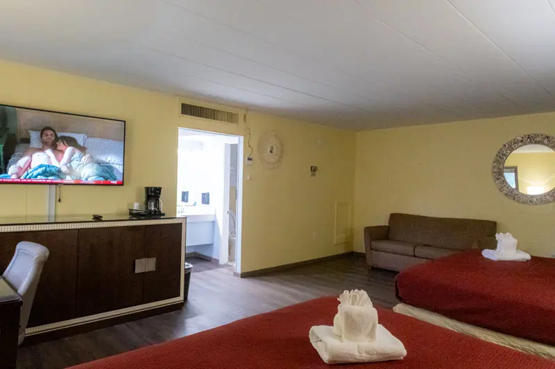 Two king beds and a sofa in a Heart of Manteo guest room